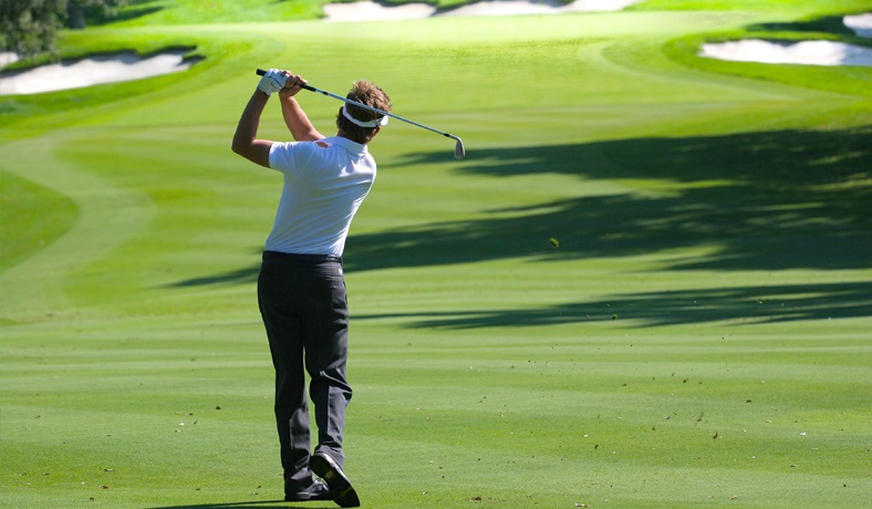 man swings club in sarasota golf community
